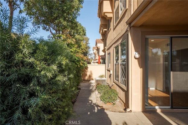 view of side of home featuring cooling unit and a patio area