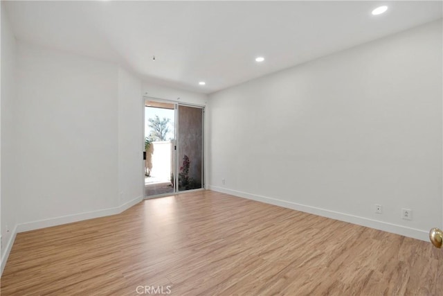 unfurnished room with light hardwood / wood-style flooring