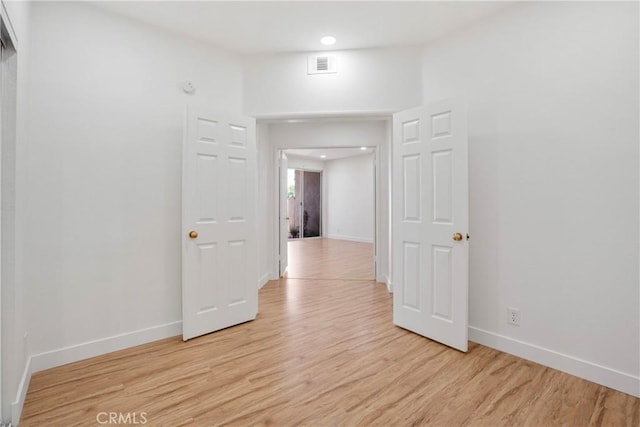 corridor with light hardwood / wood-style flooring