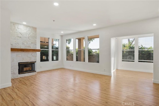 unfurnished living room featuring a fireplace and light wood-type flooring