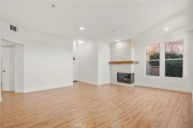 unfurnished living room featuring a fireplace and light wood-type flooring