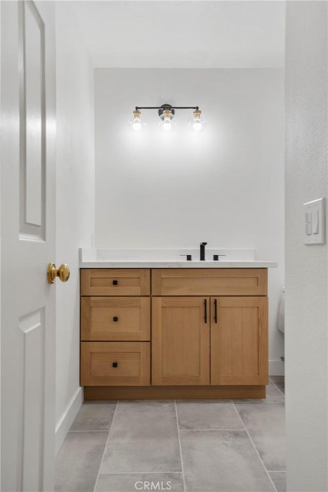 bathroom with sink, tile patterned floors, and toilet