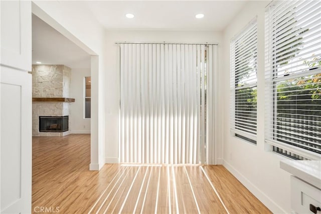 unfurnished room featuring a fireplace and light wood-type flooring