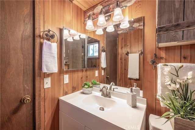 bathroom with vanity and wooden walls