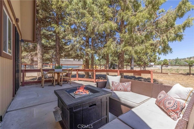 view of patio / terrace featuring an outdoor living space with a fire pit