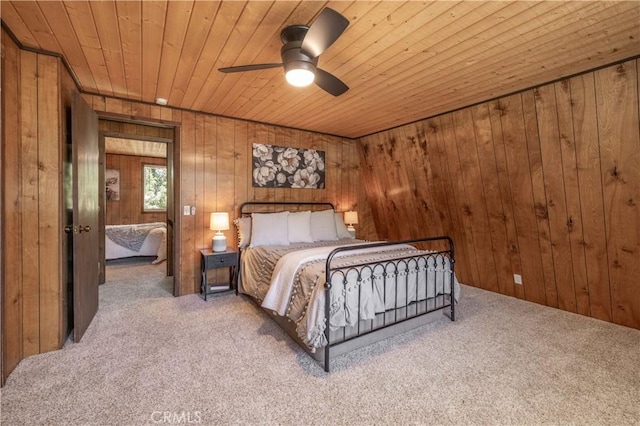 bedroom with wood ceiling, ceiling fan, wooden walls, and carpet floors