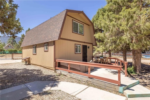 view of home's exterior featuring a wooden deck