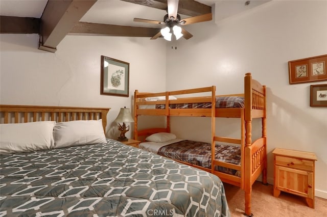 bedroom featuring beamed ceiling, ceiling fan, and carpet floors