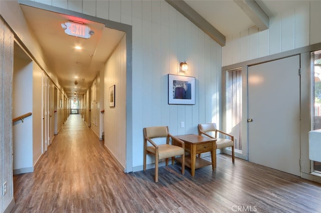 corridor featuring hardwood / wood-style floors and vaulted ceiling with beams