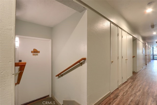 staircase with hardwood / wood-style flooring