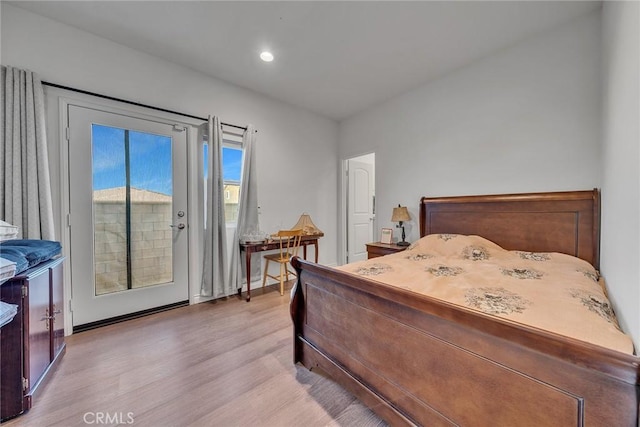 bedroom featuring access to exterior and light hardwood / wood-style flooring