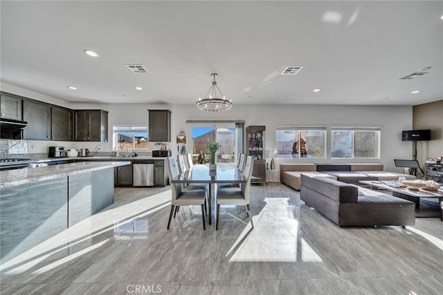 dining space with a chandelier and a wealth of natural light