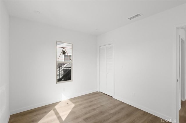 empty room with hardwood / wood-style flooring