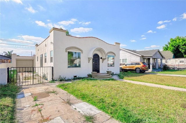 view of front of house featuring a garage and a front lawn