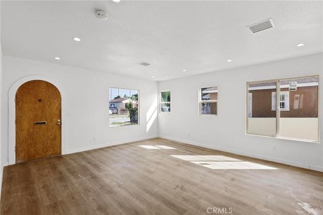 unfurnished room with hardwood / wood-style flooring