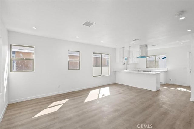 unfurnished living room with light wood-type flooring