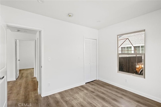 spare room with hardwood / wood-style flooring