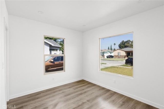 unfurnished room with hardwood / wood-style floors