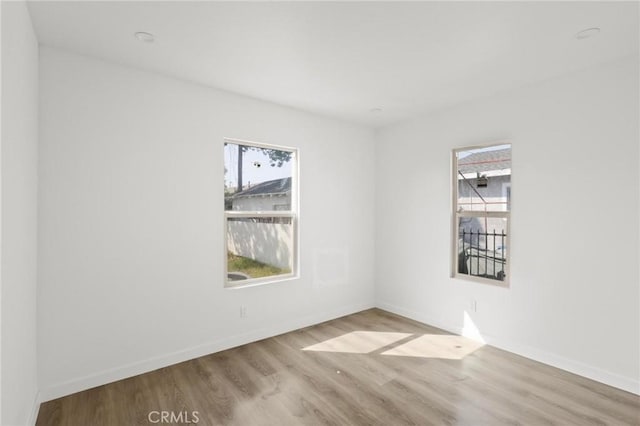 unfurnished room with light hardwood / wood-style flooring