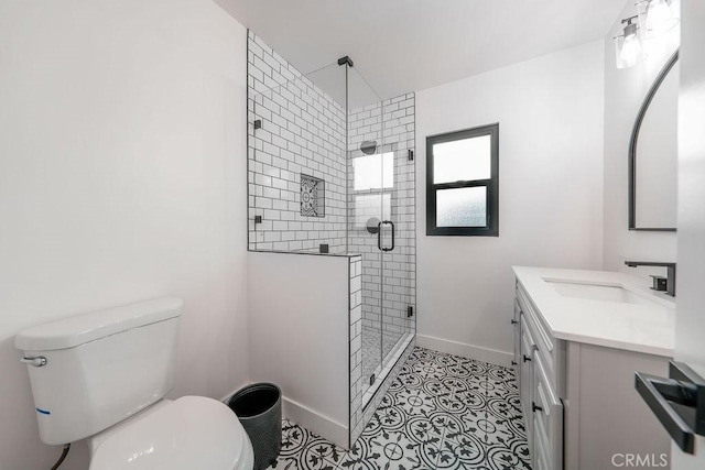 bathroom with walk in shower, tile patterned floors, vanity, and toilet