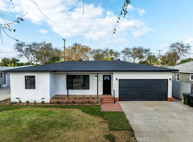 ranch-style home featuring a garage and a front lawn