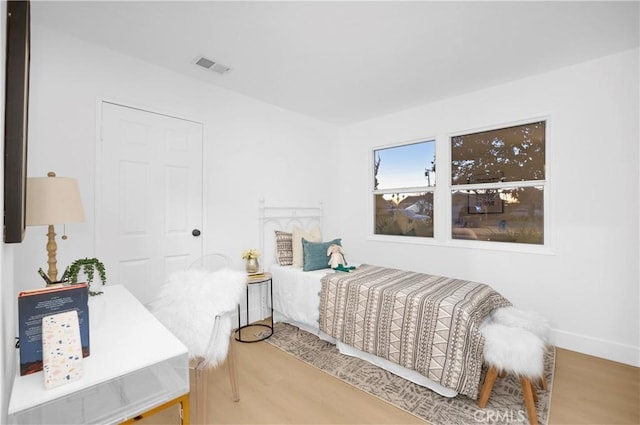 bedroom with wood-type flooring