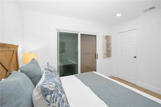 bedroom with wood-type flooring and a closet