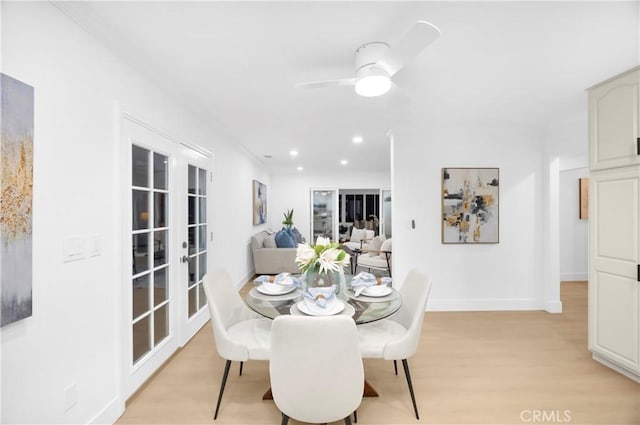 dining room with light hardwood / wood-style flooring, french doors, and ceiling fan