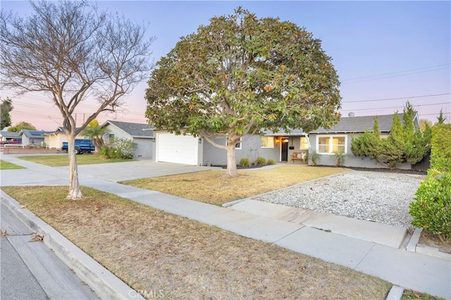 view of front of property featuring a garage and a lawn