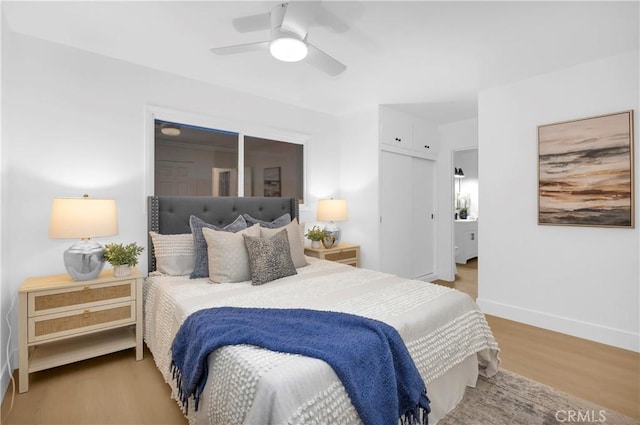 bedroom featuring light hardwood / wood-style flooring, a closet, and ceiling fan