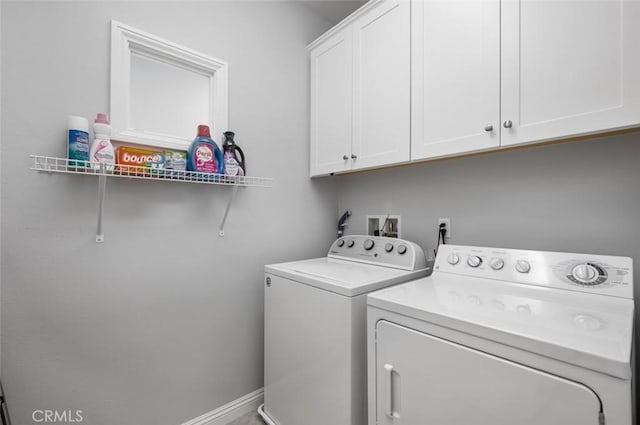 laundry area with cabinets and independent washer and dryer