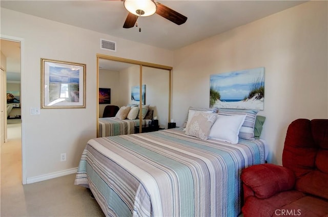 bedroom featuring ceiling fan, light colored carpet, and a closet