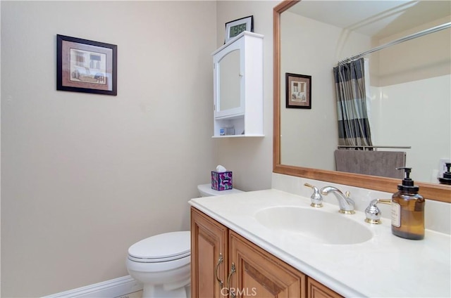 bathroom featuring vanity, toilet, and a shower with shower curtain