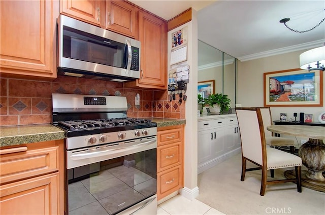 kitchen featuring backsplash, crown molding, light tile patterned flooring, and appliances with stainless steel finishes