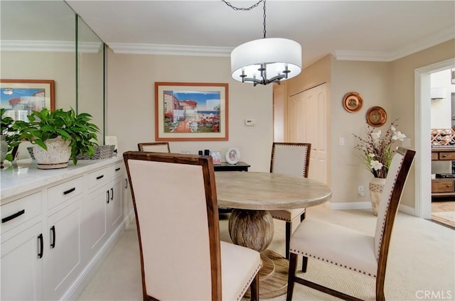 dining room with light carpet and ornamental molding