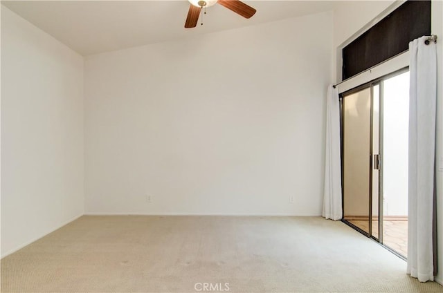 spare room with ceiling fan, a wealth of natural light, and light colored carpet