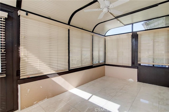 unfurnished sunroom featuring ceiling fan