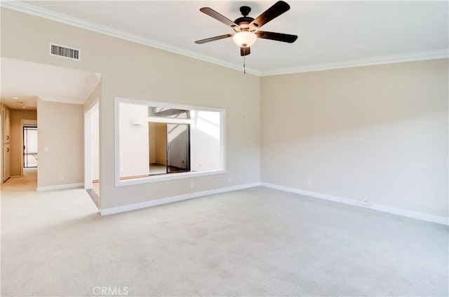 empty room with light carpet, baseboards, visible vents, ceiling fan, and ornamental molding