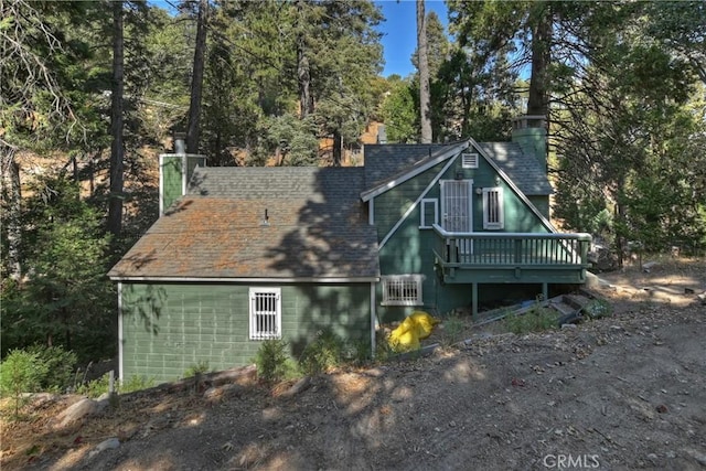 back of house featuring a wooden deck