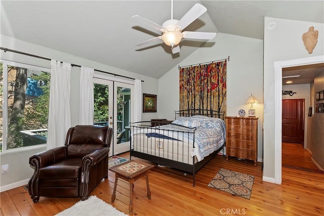 bedroom with multiple windows, ceiling fan, vaulted ceiling, and hardwood / wood-style floors