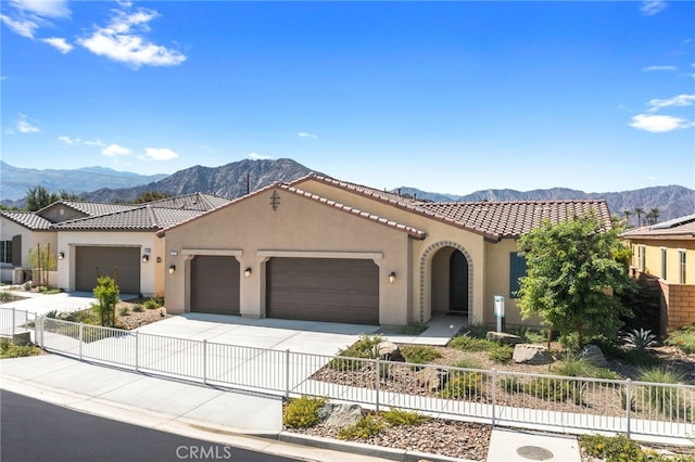 mediterranean / spanish-style house featuring a garage and a mountain view