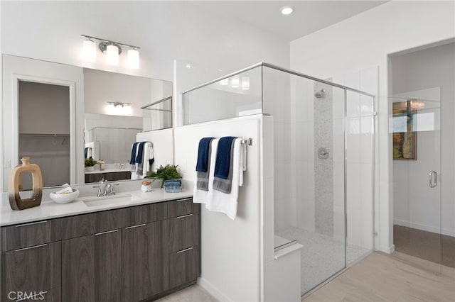 bathroom with vanity and a shower with shower door