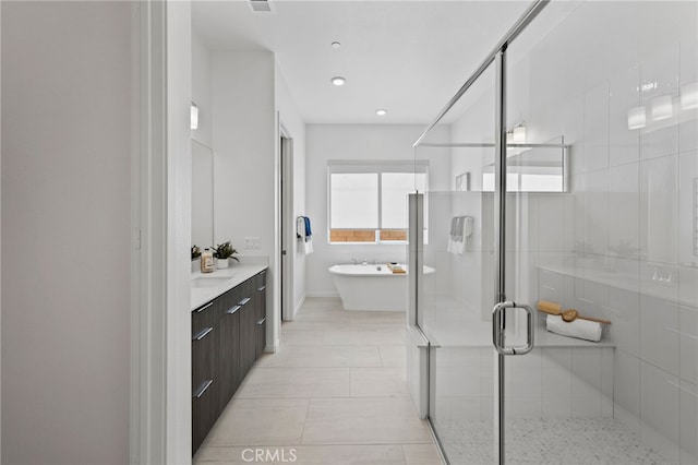 bathroom featuring vanity and shower with separate bathtub