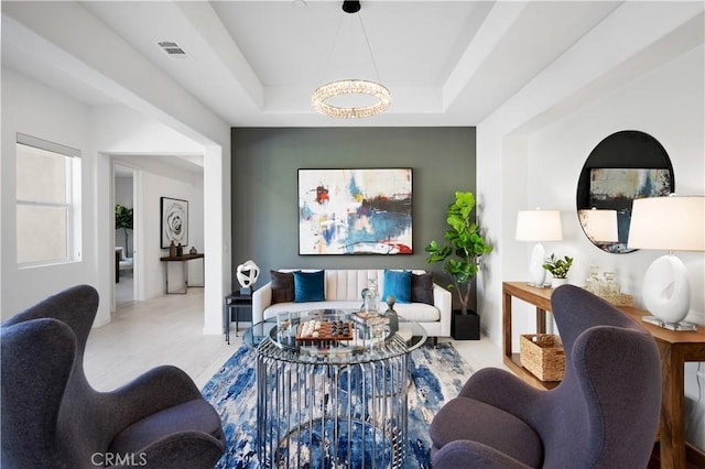 living room featuring a raised ceiling