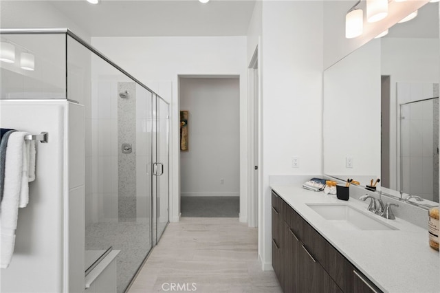 bathroom with vanity, hardwood / wood-style floors, and an enclosed shower