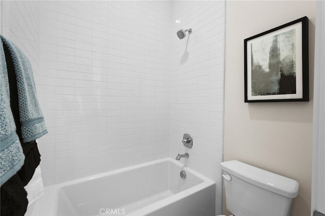 bathroom featuring toilet and tiled shower / bath