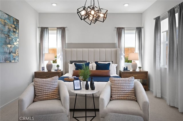 living area with light carpet and a chandelier