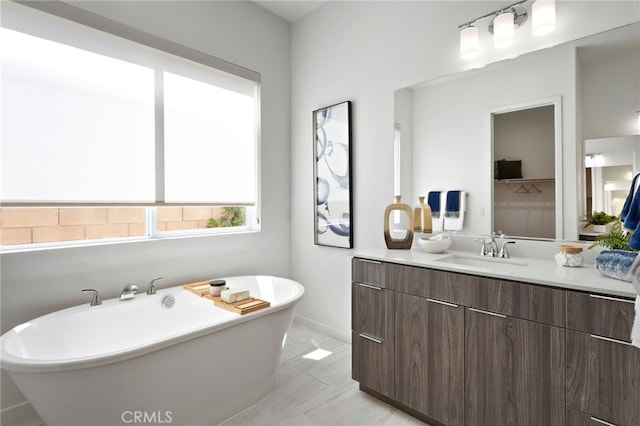 bathroom with vanity and a tub