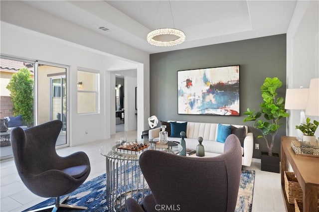 living room featuring a raised ceiling