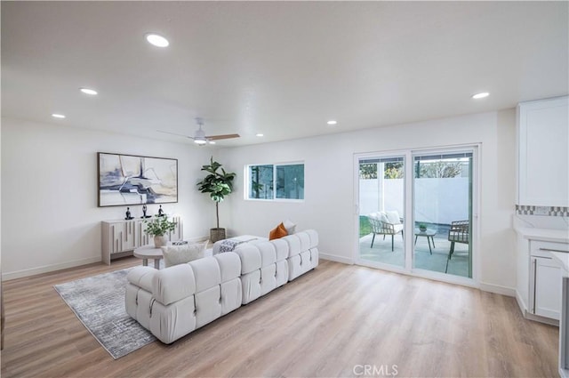 living room with ceiling fan and light wood-type flooring